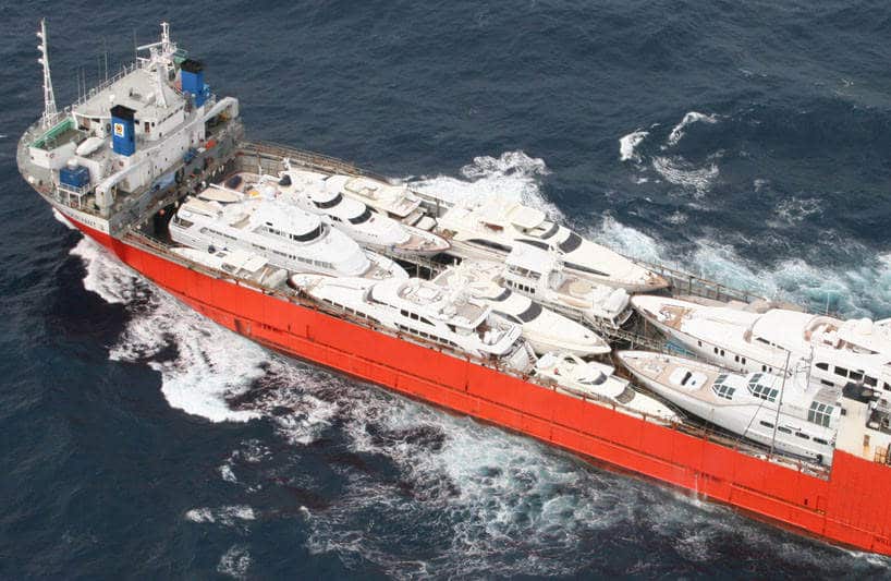 Aerial view of motorboats stacked on ship deck at sea